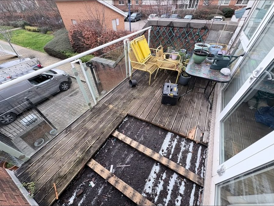 Worn balcony decking with boards lifted
